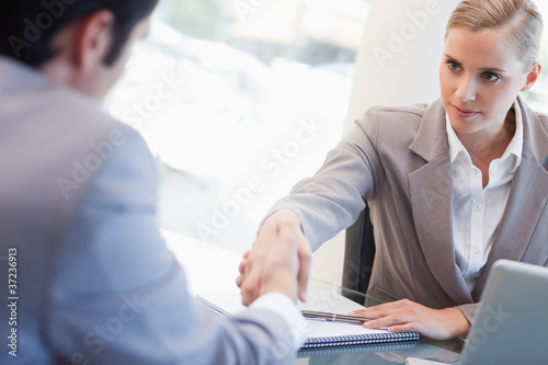 Photo: Serious manager interviewing a male applicant Serious manager interviewing a male applicant