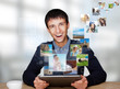 Portrait of young happy man sharing his photo and video files in Portrait of young happy man sharing his photo and video files in
