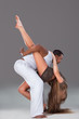 Young couple dances Caribbean Salsa, studio shot