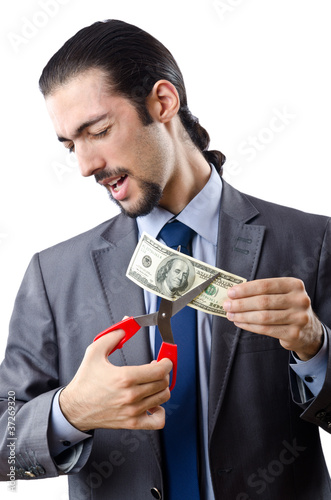 Photo: Man cutting money on white Man cutting money on white