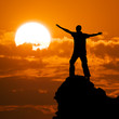 Man on peak of mountain