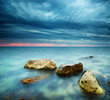 Sea and rock at the sunset. Nature composition.
