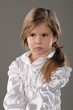 Little cute serious girl with long hair