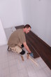 Man laying laminate flooring panels