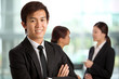 Asian Business man with colleague's in background