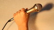 Vocalist singing with a chrome microphone closeup