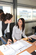 Photo: Woman asking her colleague a question Woman asking her colleague a question