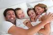 Family portrait laying in bed