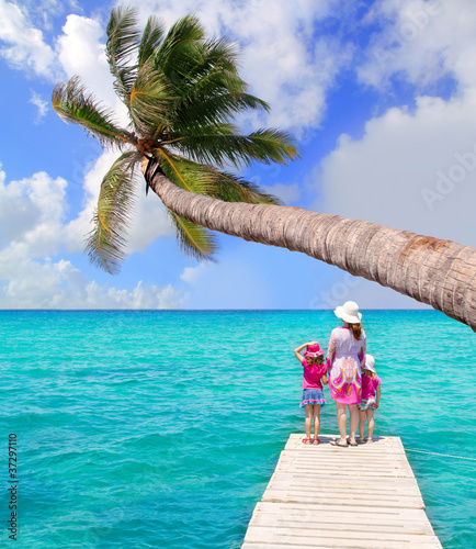 Photo: Daughters and mother in jetty on tropical beach Daughters and mother in jetty on tropical beach