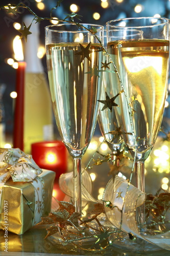 Photo: Closeup of champagne in glasses and bottle . Closeup of champagne in glasses and bottle .