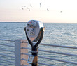 Public beach binoculars on a dock at sunset, Florida. Public beach binoculars on a dock at sunset, Florida.