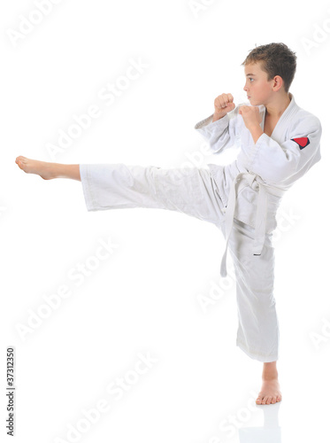 Photo: Young boy training karate. Young boy training karate.