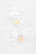 paper butterfly and three sugar blossom flowers on white old tab paper butterfly and three sugar blossom flowers on white old tab