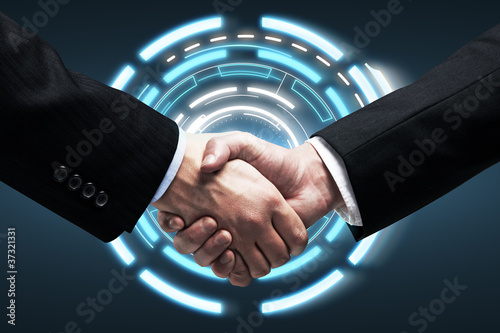 Photo: Handshake on background a touch screen interface Handshake on background a touch screen interface