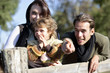 Family leaning against wooden fence