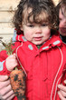Little boy holding organic carrot