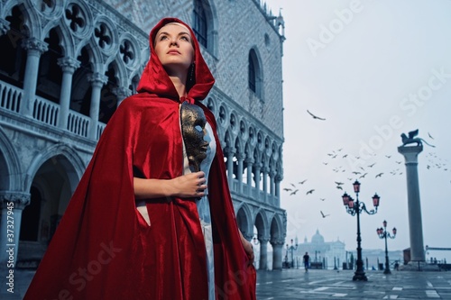 Photo: Beautiful woman in red cloak against Dodge's Palace Beautiful woman in red cloak against Dodge's Palace