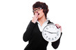 businesswoman holding clock and yawning businesswoman holding clock and yawning