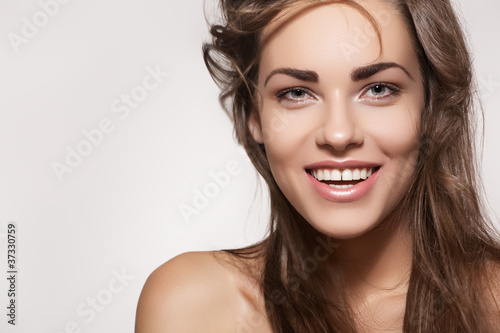 Photo: Happy beautiful woman. Female smile with healthy white teeth Happy beautiful woman. Female smile with healthy white teeth