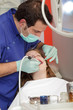 Photo: Dentist drilling tooth to patient Dentist drilling tooth to patient