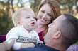 Photo: Cute Child Looks Up to Sky as Young Parents Smile Cute Child Looks Up to Sky as Young Parents Smile