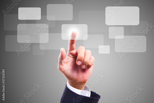 Photo: Hand pushing button on screen Hand pushing button on screen