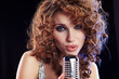 Portrait of a glamorous girl with mike singing song Portrait of a glamorous girl with mike singing song
