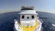 Dive boat travelling over a calm ocean.