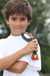 Little boy holding catapult