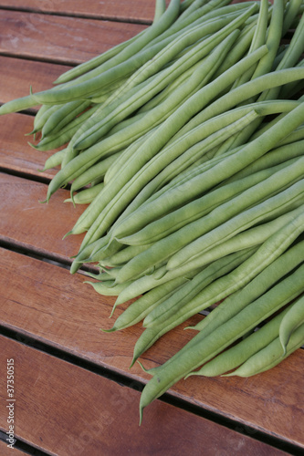Photo: Fresh ripe green beans on garden table Fresh ripe green beans on garden table