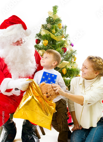 Photo: Santa Claus giving Christmas gifts to children Santa Claus giving Christmas gifts to children