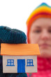 House holds woman in winter gloves