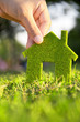 Eco house concept ,hand holding eco house icon in nature