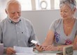Elderly couple calculating budget Elderly couple calculating budget