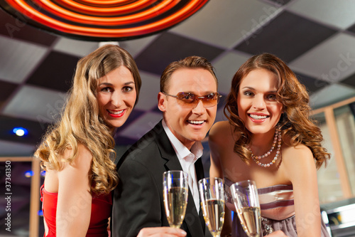 Photo: People with champagne in a bar People with champagne in a bar