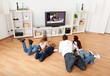 Young family watching TV at home