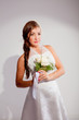 Beautiful dark haired woman in white bridal dress