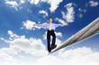 Business man balancing on the rope