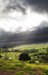 sunlight through black clouds before storm arrives