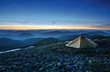 Tourist tent in the rocky mountains and first star Tourist tent in the rocky mountains and first star