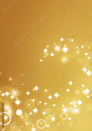 Photo: Gold background with circle light effects and shiny stars Gold background with circle light effects and shiny stars