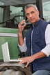Photo: Farmer with a laptop and cellphone Farmer with a laptop and cellphone