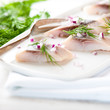 Herring fillets with dill and onion on a plate