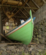 Traditional Faroese fishing boat made ​​of wood in an old bo