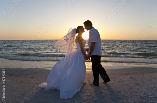 Photo: Bride & Groom Married Couple Kissing Sunset Beach Wedding Bride & Groom Married Couple Kissing Sunset Beach Wedding