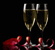 Two glasses with white wine over black background