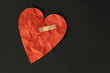 broken red heart on black background