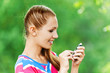 Foto: woman with mobile phone in hand woman with mobile phone in hand
