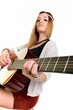 An attractive young teenage woman with an acoustic guitar An attractive young teenage woman with an acoustic guitar