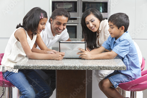Photo: Asian Indian Family Using Tablet Computer at Home Asian Indian Family Using Tablet Computer at Home